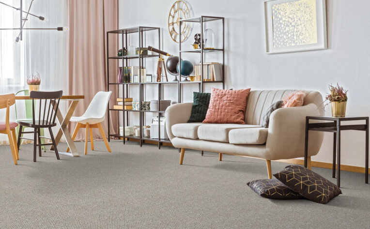 modern living room with beige carpet and pink accents